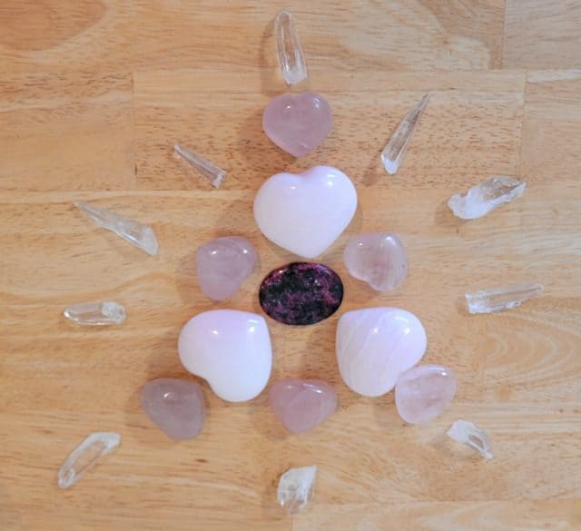 Example Crystal Grid for Love with stones and crystals in a burst pattern